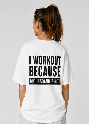 Person wearing a white t-shirt with humorous text on the back, standing against a plain background.