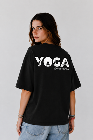 Girl wearing a black t-shirt with 'Yoga' text on the back.
