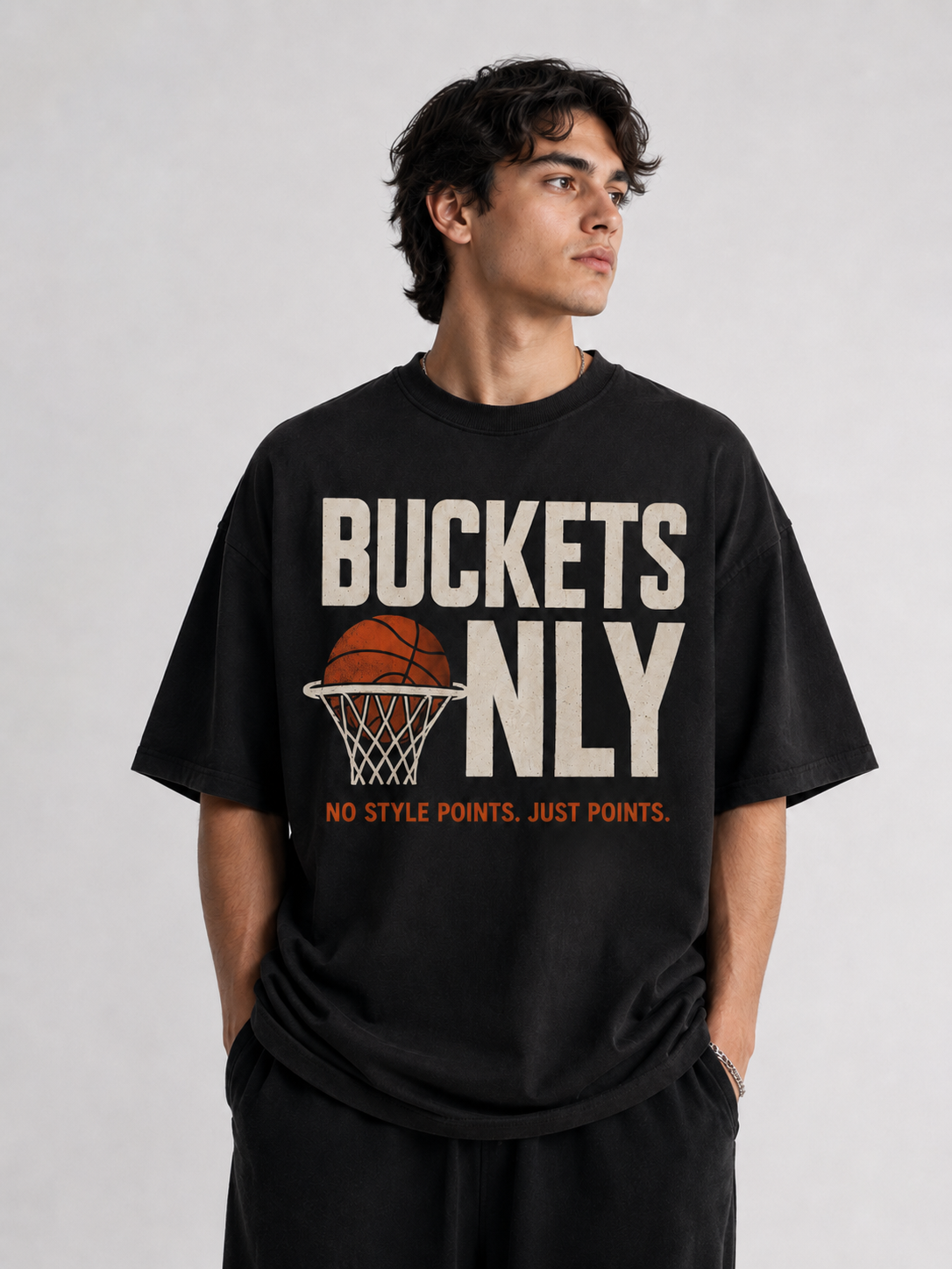 Person wearing a black t-shirt with 'Buckets Only' text and graphic on a plain background