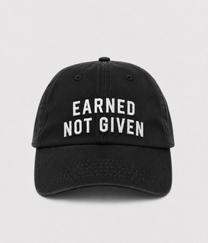 A black baseball cap with 'EARNED NOT GIVEN' embroidered in white capital letters on the front.